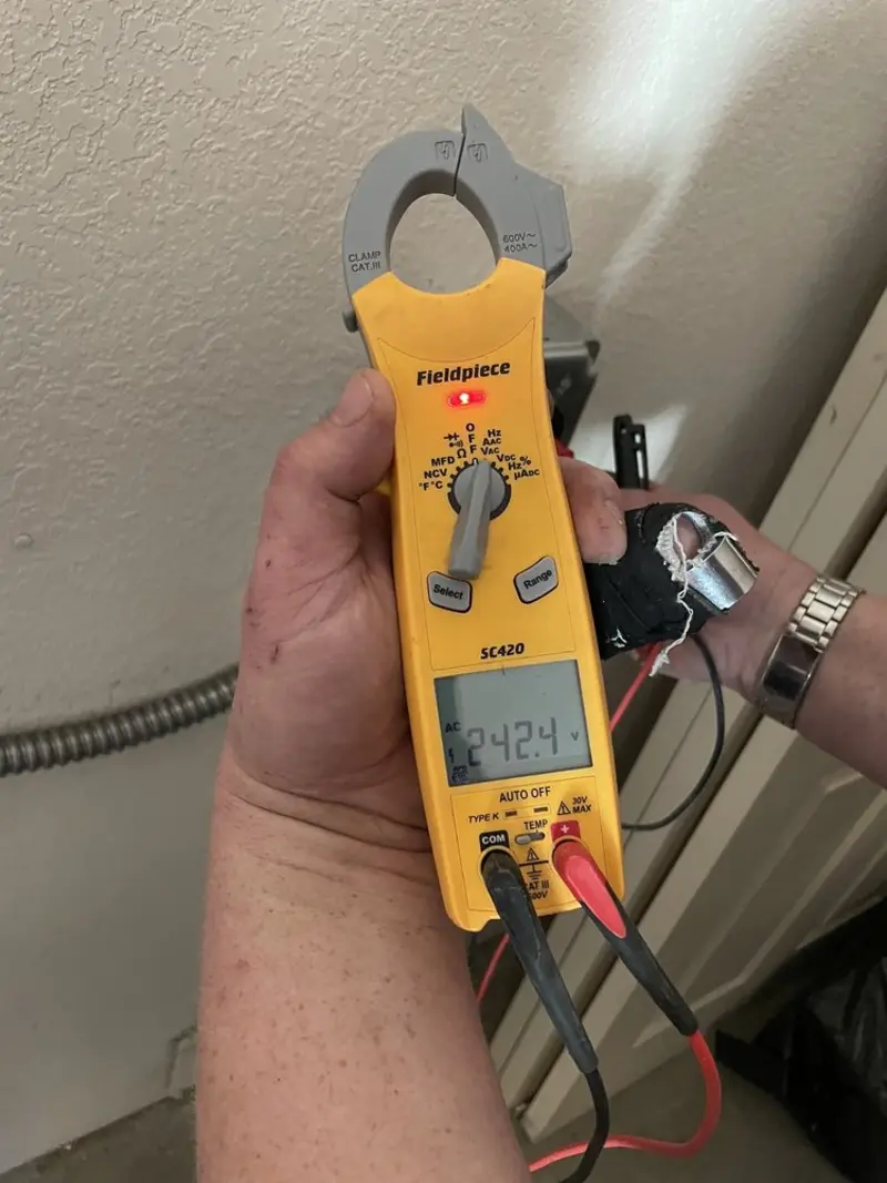 Voltage testing with clamp meter during Recessed Lighting Installation in Raceland